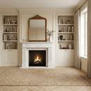 Living room with a fireplace, bookshelves, and a large mirror.