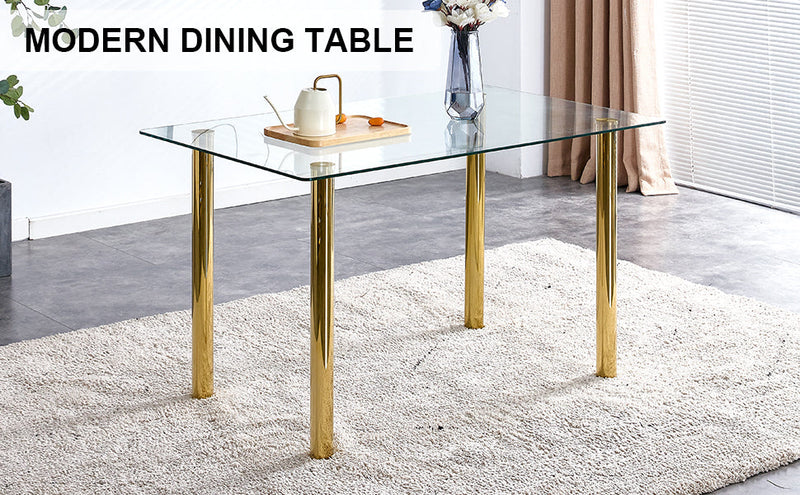 A modern minimalist style glass dining table. Transparent tempered glass tabletop with a thickness of 0.3 feet and golden metal legs. Suitable for restaurants and living rooms. 51"x31.4"x29.5"