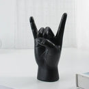 Chic black glossy rock hand gesture sculpture living room decor by Decorbites