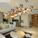 GobekUsa Contemporary Island Lamp: 10 Glass Bulbs in Clear/Amber/Smoke Suspended Fixture - Black/Brass for Bedroom
