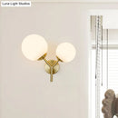 GobekUsa Contemporary White Glass Spherical Sconce with 2 Gold Heads - Wall Mounted Light Fixture