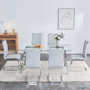 A modern minimalist rectangular glass dining table with tempered glass tabletop and silver metal legs, suitable for kitchens, restaurants, and living rooms,63"x35.4"x30"
