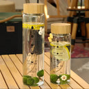 Modern glass water bottle with wood lid and tea filter kitchen accessory by Decorbites
