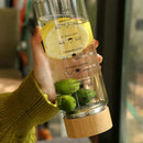 Modern glass water bottle with wood lid and tea filter kitchen accessory by Decorbites