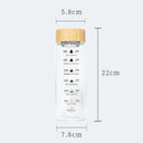 Minimalist glass water bottle with bamboo lid and kitchen time scale by Decorbites
