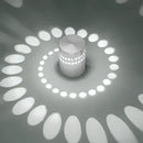 Blue aluminum spiral led wall lamp for bedroom circular light patterns by Decorbites