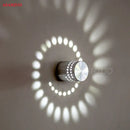 Blue aluminum spiral led wall lamp for bedroom circular light patterns by Decorbites