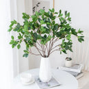 Vibrant red artificial maple leaf bouquet in white vase living room by Decorbites