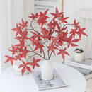 Vibrant red artificial maple leaf bouquet in white vase living room by Decorbites