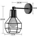 Retro black iron cage wall lamp for bedroom with amber bulb by Decorbites