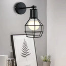 Retro black iron cage wall lamp for bedroom with amber bulb by Decorbites