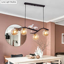 GobekUsa Contemporary Metal Branch Hanging Lamp Island Pendant - 4-Light Black/Gold with Bird Deco and Smoke Grey/Cognac Glass Shade