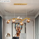 GobekUsa Contemporary Metal Branch Hanging Lamp Island Pendant - 4-Light Black/Gold with Bird Deco and Smoke Grey/Cognac Glass Shade