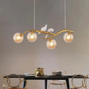 GobekUsa Contemporary Metal Branch Hanging Lamp Island Pendant - 4-Light Black/Gold with Bird Deco and Smoke Grey/Cognac Glass Shade