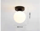 Modern brass & black glass ball ceiling light for living room by Decorbites
