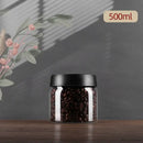 Clear glass vacuum sealed coffee beans jar kitchen storage with gold seal by Decorbites