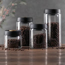 Clear glass vacuum sealed coffee beans jar kitchen storage with gold seal by Decorbites