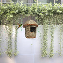 Handwoven straw bird nest with hanging rope for garden decor by Decorbites