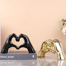 Glossy gold silver & black gesture heart sculpture living room decor by Decorbites
