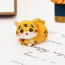 Lucky tiger figurine yellow living room new year decor holding gold bars by Decorbites