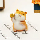 Lucky tiger figurine yellow living room new year decor holding gold bars by Decorbites