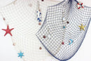Nautical theme beige & navy blue fishing net wall decor living room by Decorbites