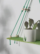 Boho pink green wooden macrame hanging shelf for kids room by Decorbites