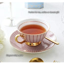 Elegant gold porcelain tea set dining room rack with bird figurine by Decorbites