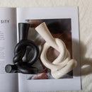 Geometric black & white ceramic knot candle stand living room decor by Decorbites