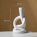 Geometric black & white ceramic knot candle stand living room decor by Decorbites