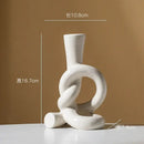 Geometric black & white ceramic knot candle stand living room decor by Decorbites