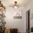 Geometric cage iron ceiling light fixture dining room exposed bulb by Decorbites