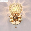 GobekUsa Globe Cutout Metal Shade Crystal Wall Sconce in Gold with Dropped Crystal Ball Accent