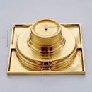 Gold square bathroom shower drain with interchangeable grates by Decorbites