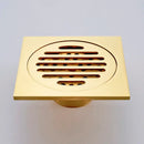 Gold square bathroom shower drain with interchangeable grates by Decorbites
