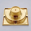 Gold square bathroom shower drain with interchangeable grates by Decorbites