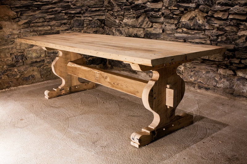 Trestle dining table made of reclaimed solid wood. Modern farmhouse wooden table with antique design