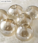 GobekUsa Mid-Century Modern Gold Metal Pendant with Spherical Amber Glass - Island Ceiling Light for Dining Table