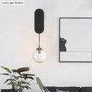 GobekUsa Minimalist Clear Glass Wall Sconce with 1 Light - Black Wall Mounted Fixture