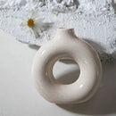 Minimalist speckled off-white ceramic donut candle holder dining room by Decorbites
