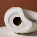 Minimalist speckled off-white ceramic donut candle holder dining room by Decorbites