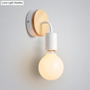 Minimalist white metal and wood bare bulb wall sconce bedroom light by Decorbites
