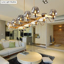 GobekUsa Contemporary Island Lamp: 10 Glass Bulbs in Clear/Amber/Smoke Suspended Fixture - Black/Brass for Bedroom