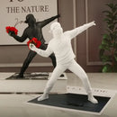 Modern black glossy bansky flower thrower sculpture office decor by Decorbites