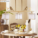 GobekUsa Modern Black/Gold Chandelier Lamp with Clear Crystal Drum Shade, Bird Accent - 3 Heads Hanging Light Fixture