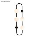 GobekUsa Modern Matte White Glass Globe Wall Sconce with 4-Light Bedroom Lighting Ideas in Black/Gold