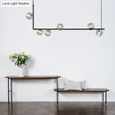 GobekUsa Modern Minimalism Black Linear 6-Light Island Pendant Lighting with Sphere Glass Shade for Living Room.
