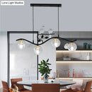 GobekUsa Minimalist Metal Wavy Island Pendant with 4-Light Black Hanging Lamp, Ball Glass Shade, and Bird Deco