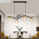 GobekUsa Minimalist Metal Wavy Island Pendant with 4-Light Black Hanging Lamp, Ball Glass Shade, and Bird Deco