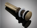Modern brass and white ceramic basin waste drain bathroom sink stopper by Decorbites